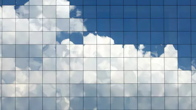 clouds reflecting on skyscraper window