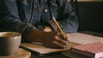 person writing in a notebook