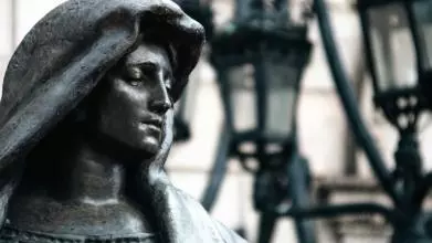 statue of a woman in a hood