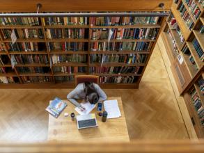 Student reading in the Howard Piper Library, St Hugh's College