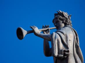 A statue blowing a trumpet